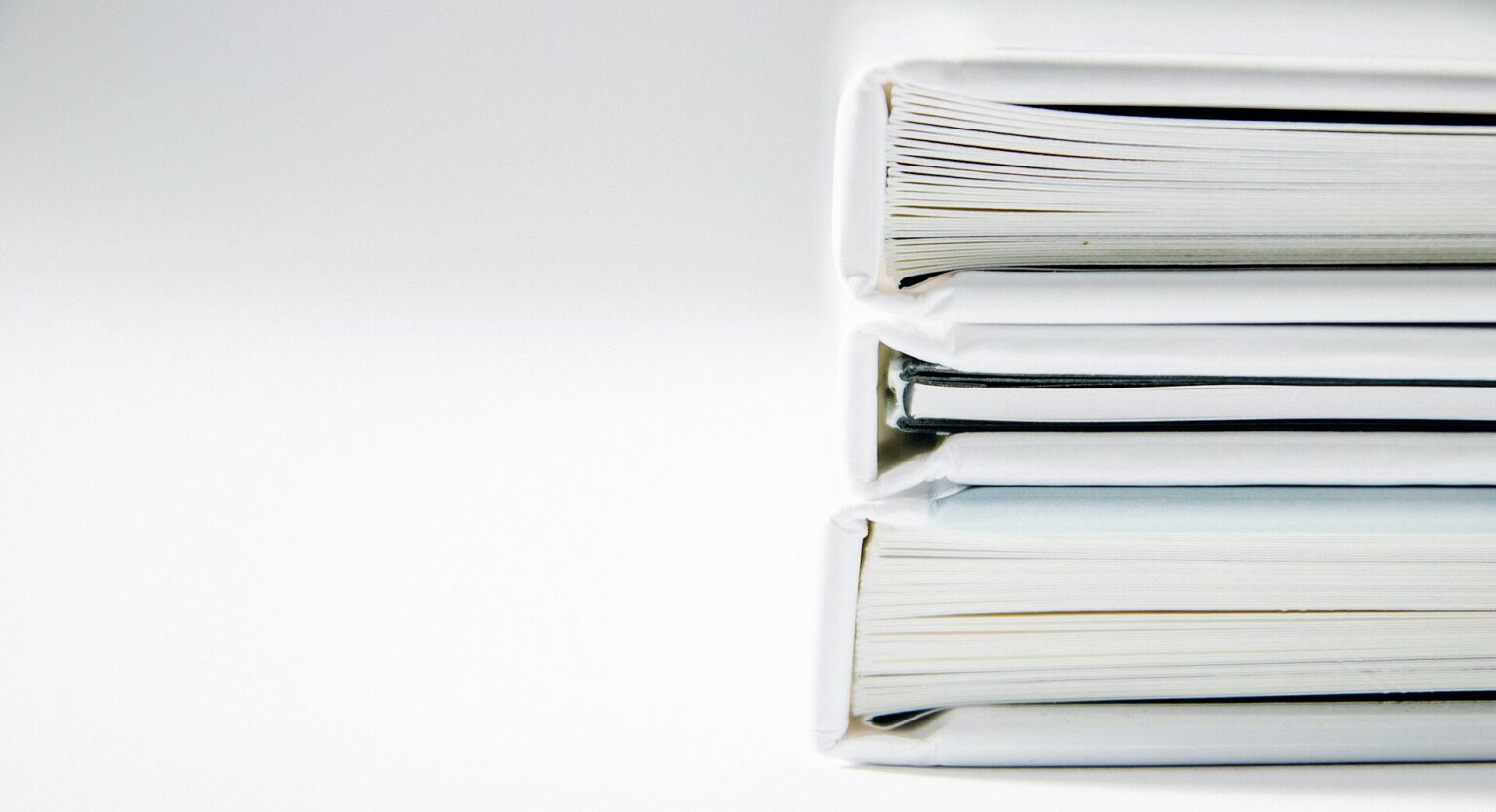 A tall stack of cardboard document folders holding filed paperwork