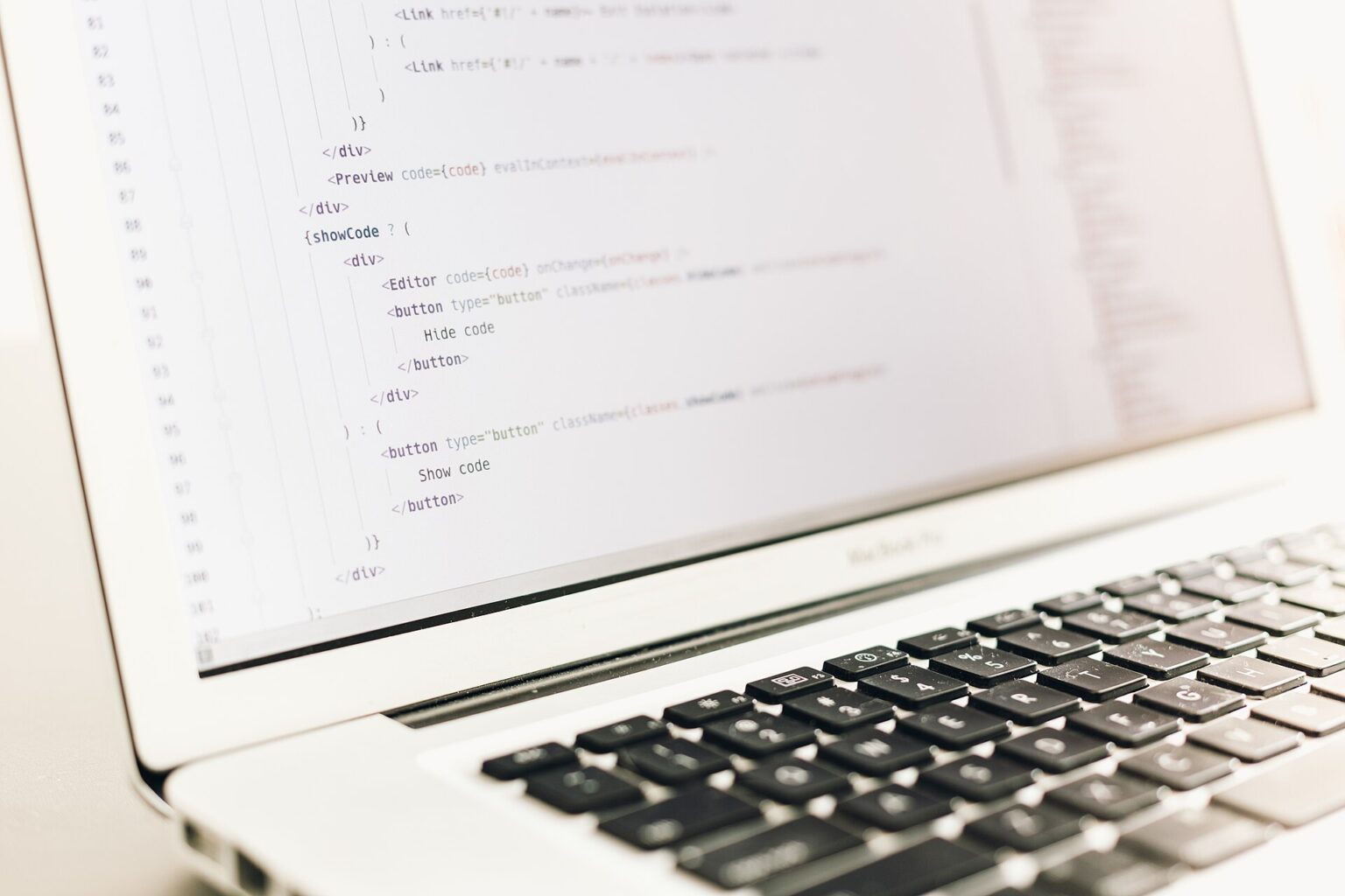 Source code open in an editor on a laptop screen, with Show code and Hide code buttons visible