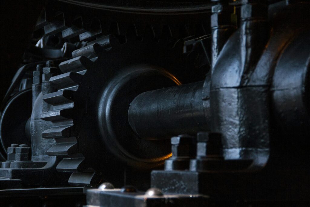 Close-up of interlocking black metal gears in machinery