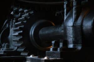 Close-up of interlocking black metal gears in machinery