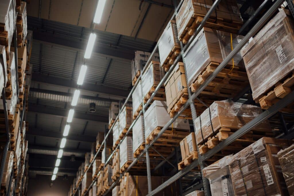 Cardboard boxes stacked on metal racking in a warehouse