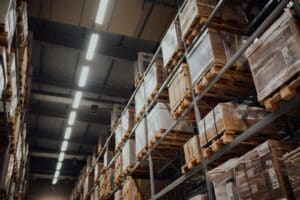 Cardboard boxes stacked on metal racking in a warehouse