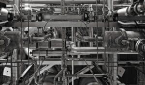 A stainless steel and red industrial machine on a production floor